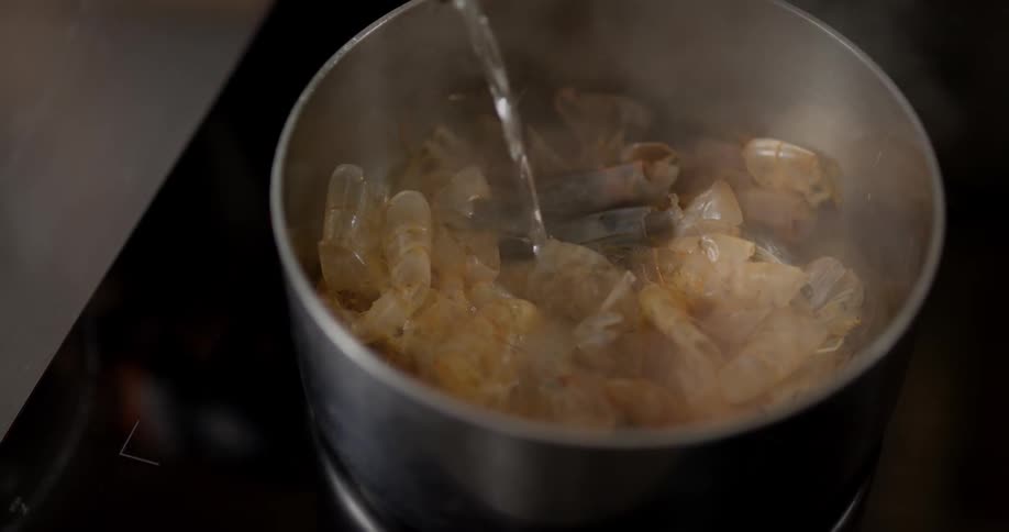Shrimp boiling with wine on a cooking pot
