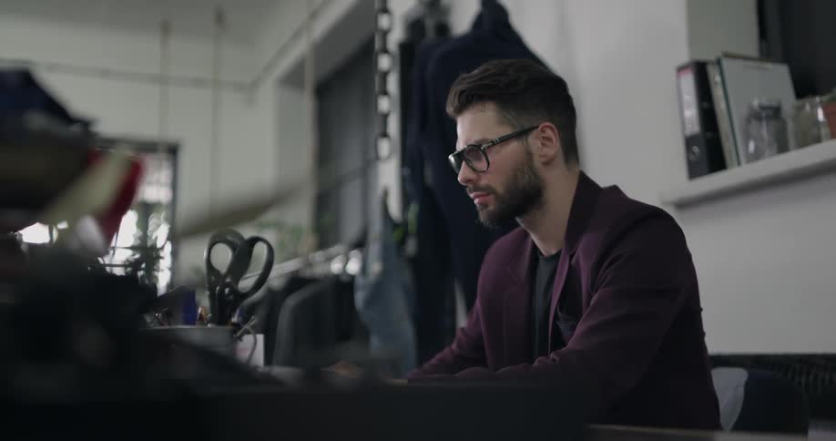 A man is working at his desk