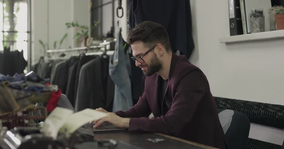 A man is looking at a laptop in a store