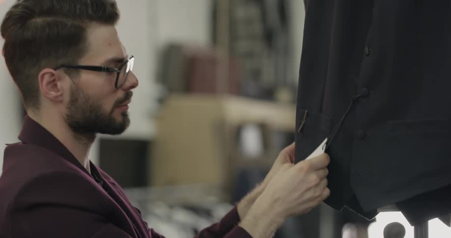 A man looking at clothing racks