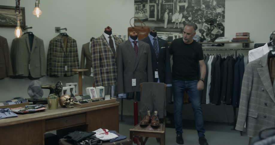 Male customer shopping for suits in a men's shop
