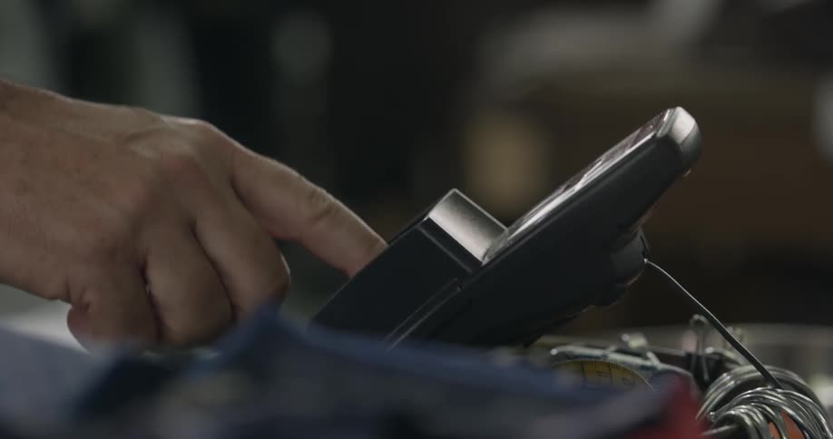 A credit card being held to a card reader