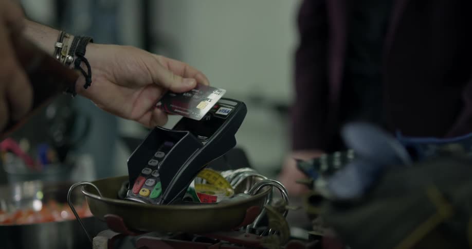 A person uses a credit card as payment