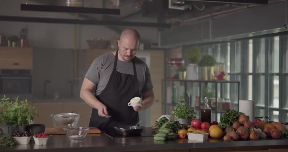 Man cooks in kitchen