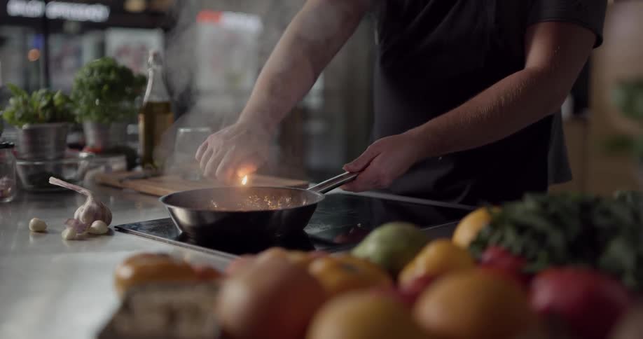 Cook adds alcohol to skillet and lights it
