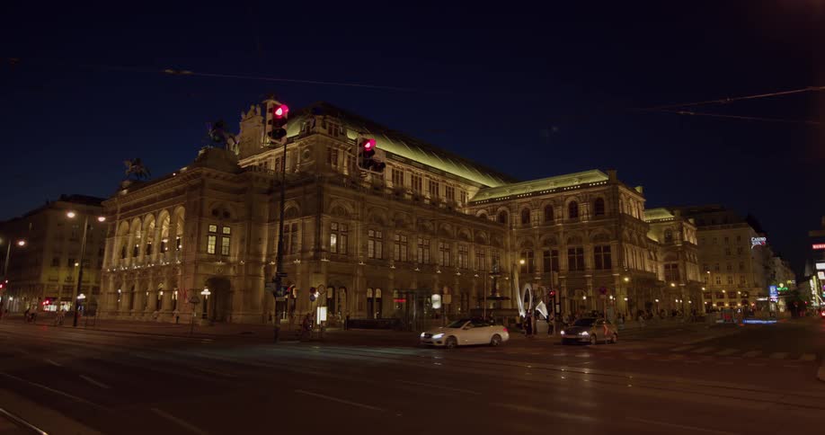 A large building on a street corner during the night