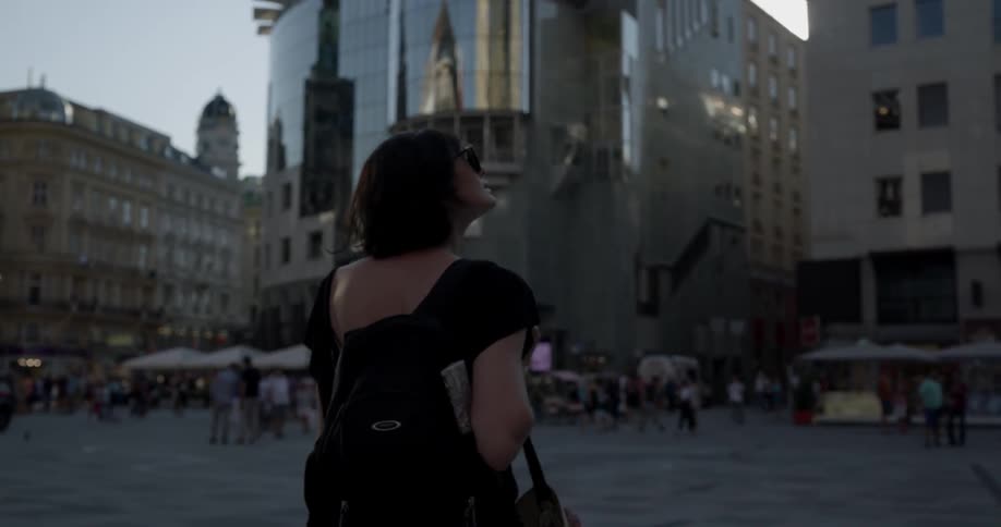 A woman walks out into the intersection in the city