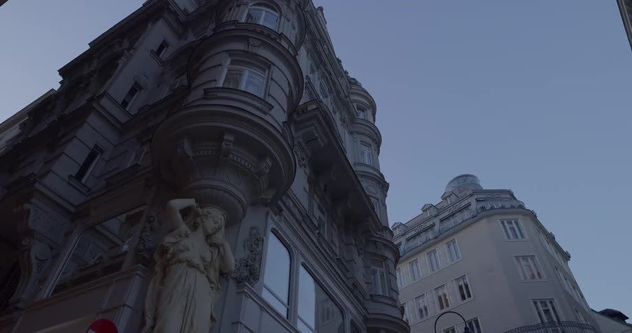 The ornate facade of an old building includes a sculpture