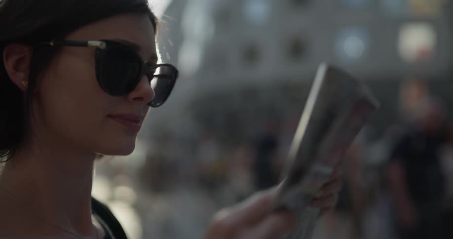 A woman reads a map in the city