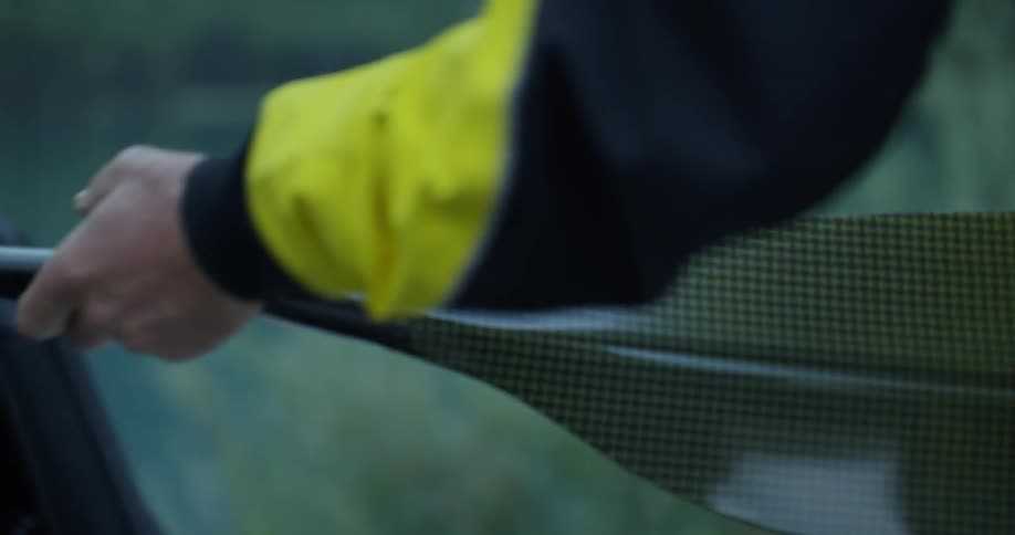 A person taking a ore out of a car