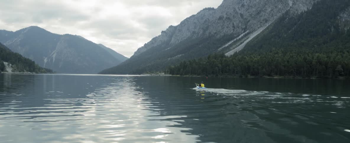 A person kayaking on a lake