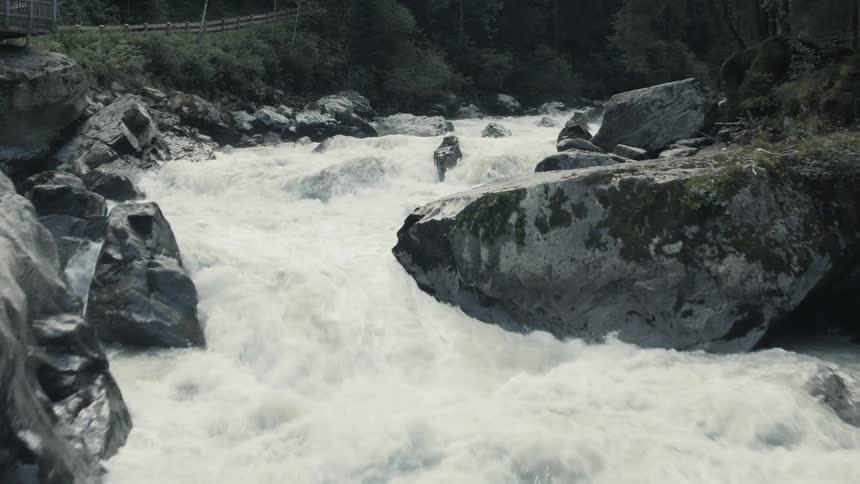 A river rushes over a small waterfall in a canyon