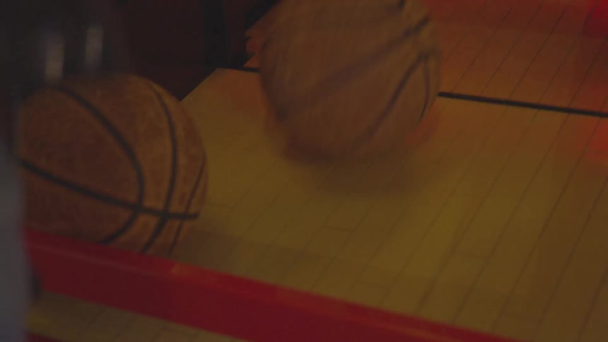 A woman playing a basketball arcade game