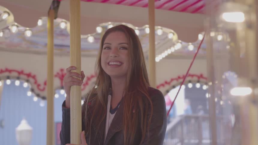 A woman riding a merry go round