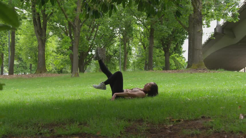 Woman exercises in lawn