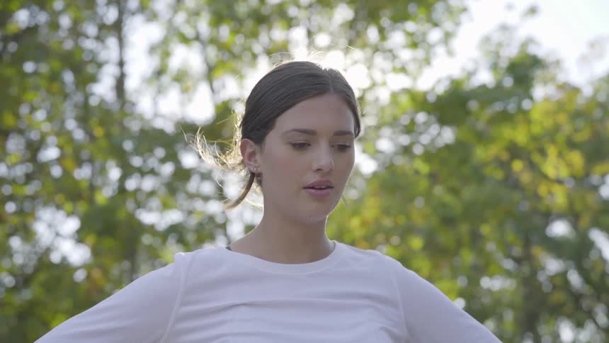 A woman catching her breath outdoors during the day
