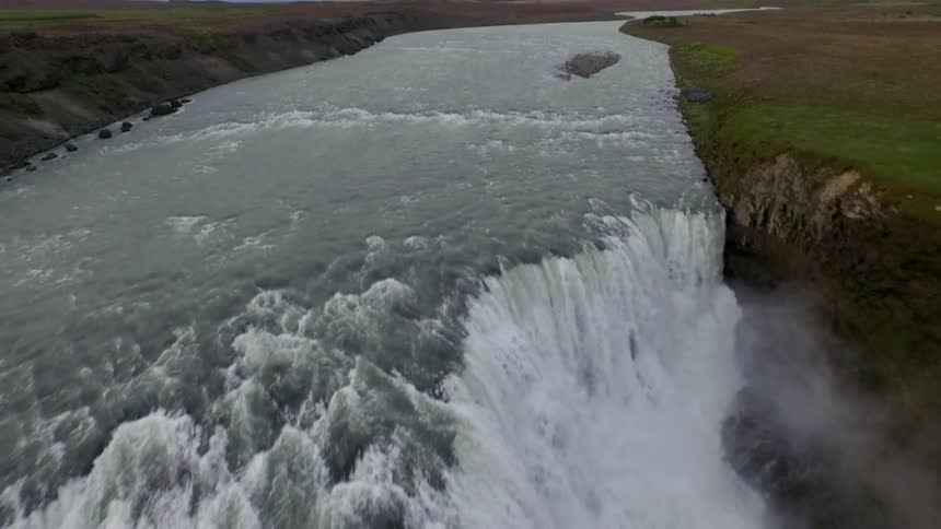 The river leads to a cascading waterfall