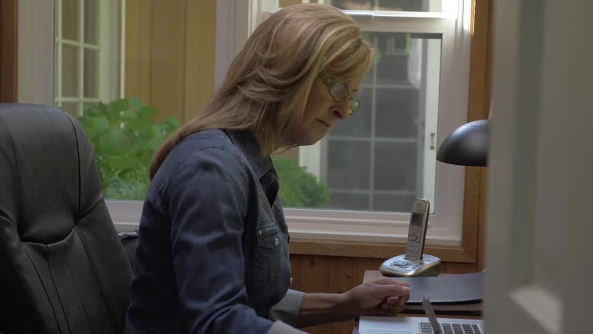 A woman typing on a laptop