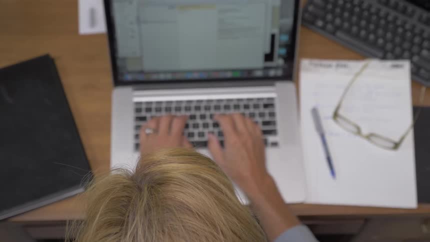A woman typing on a laptop
