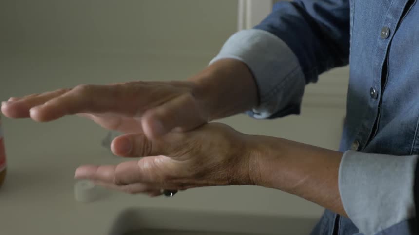 Man applying lotion on his hands