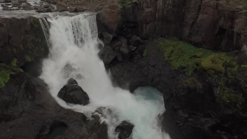 Water rushes down the fall and over rocks into a canyon