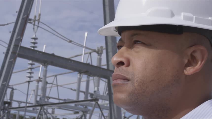 A man in a hard hat looks up