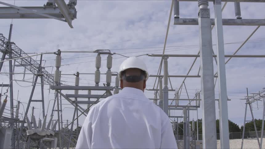 A man walking through an electrical power station