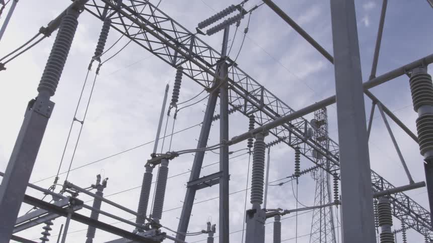 Camera is moving through the power plant under the wires