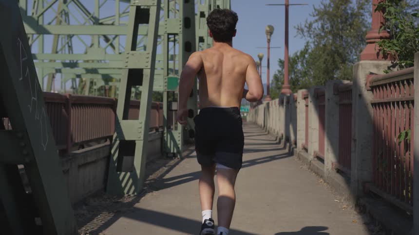 A man runs down a sidewalk