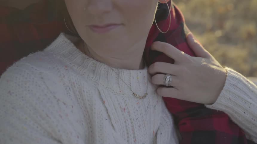 Woman holds onto another's arm