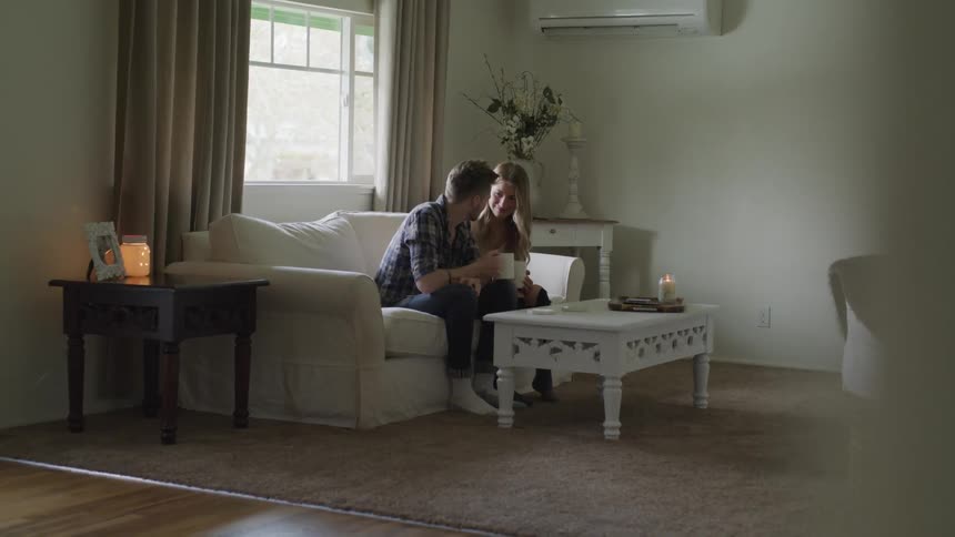 A man and woman talking while sitting on a sofa
