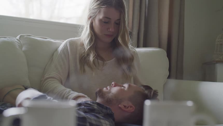 A man laying on a woman's lap