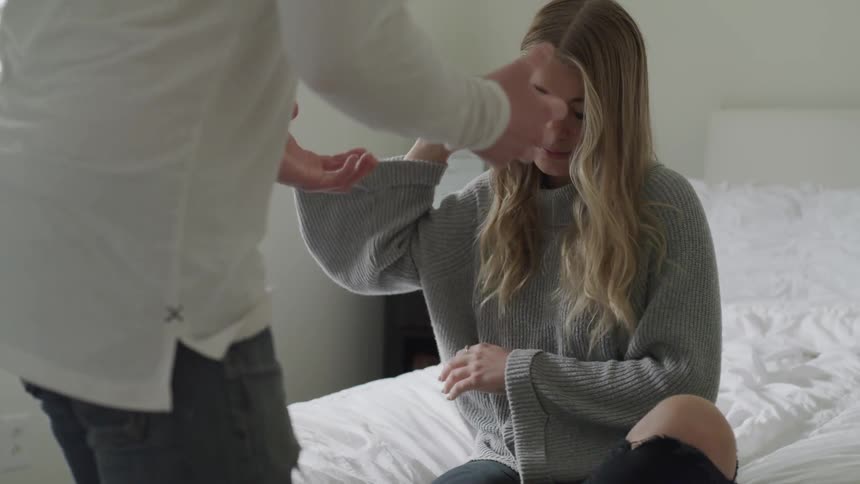 A woman takes off her wedding band and throws it while a man argues with her