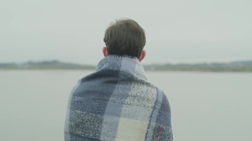 A man wearing a blanket