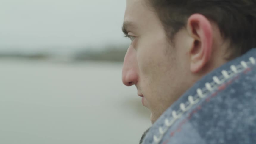 A young man stares ahead