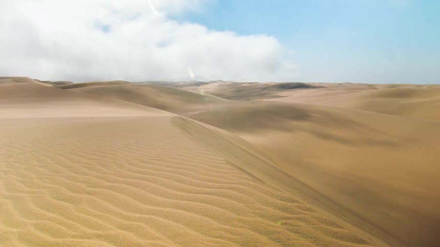 Clouds blowing over a desert