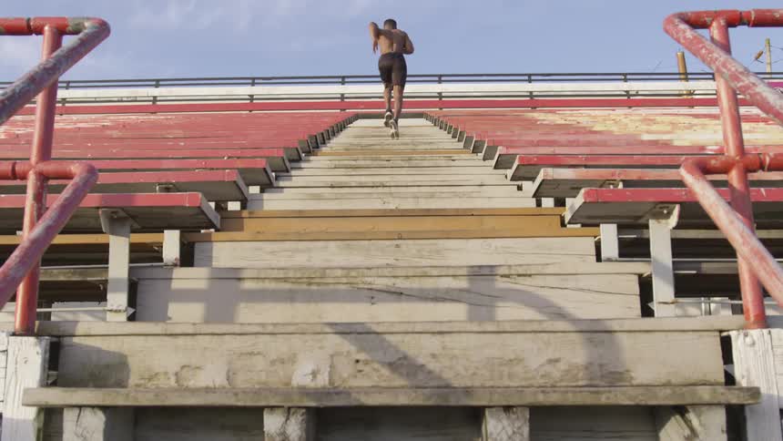 A young man runs up some stairs