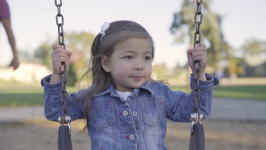 A child sitting on a swing