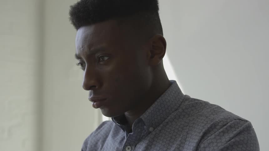 A man is leaning forward looking at something