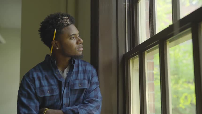 Man looking outside through a window
