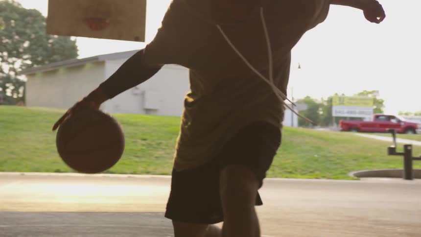 Man is dribbling basketball on the court