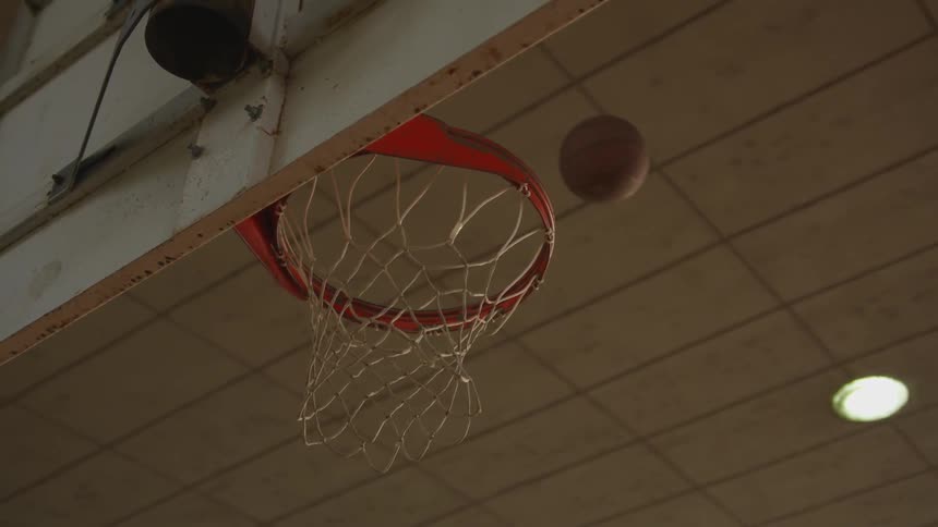 Basketball bounces off hoop rim