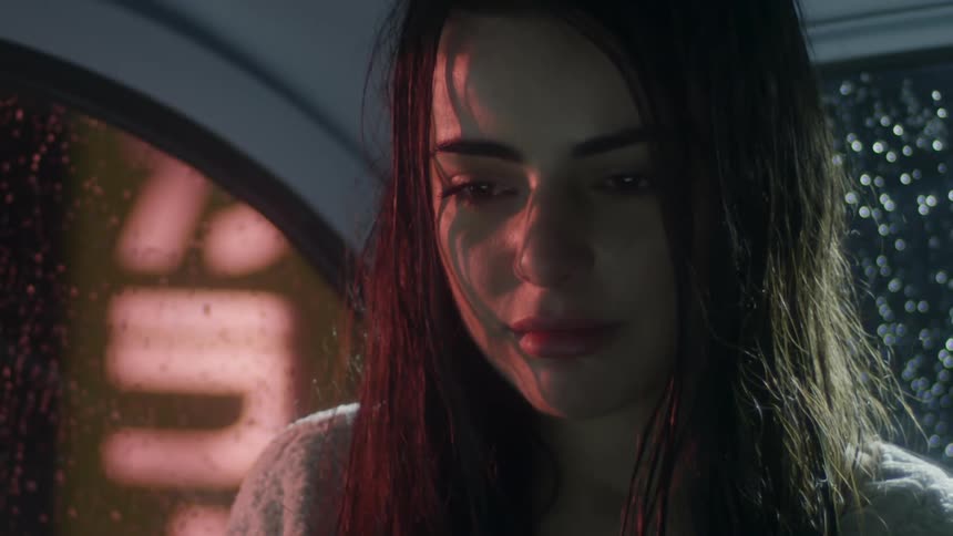 A young woman is distraught in the backseat of a vehicle
