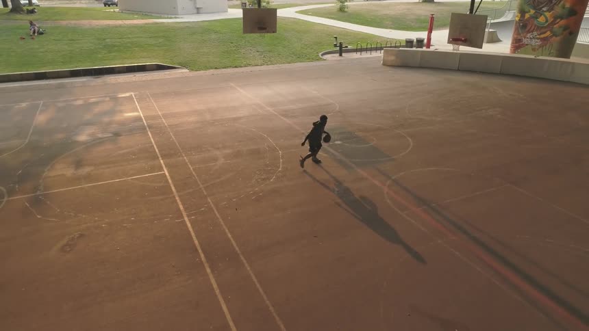 Man plays alone on a basketball court