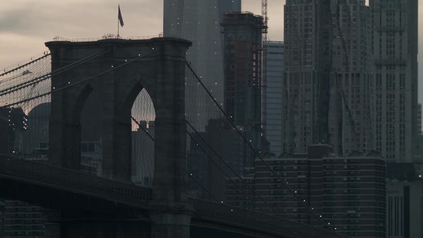 An american flag waves atop a city bridge