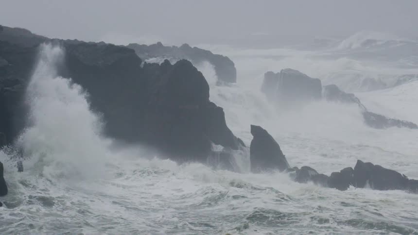 Waves from a stormy sea crashing into cliffs