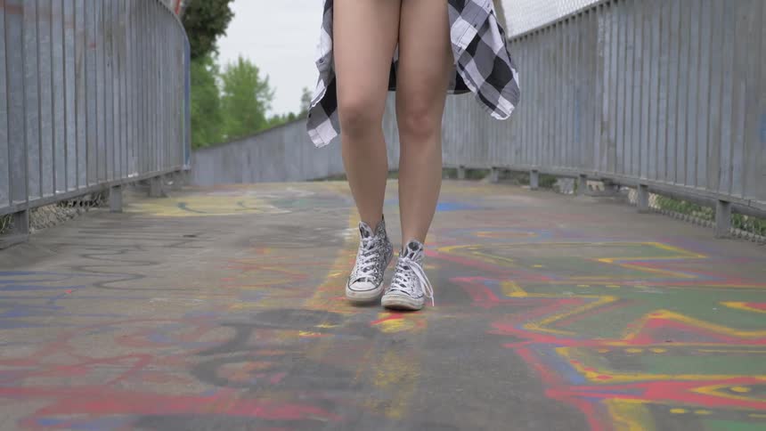 A young woman walks down the street