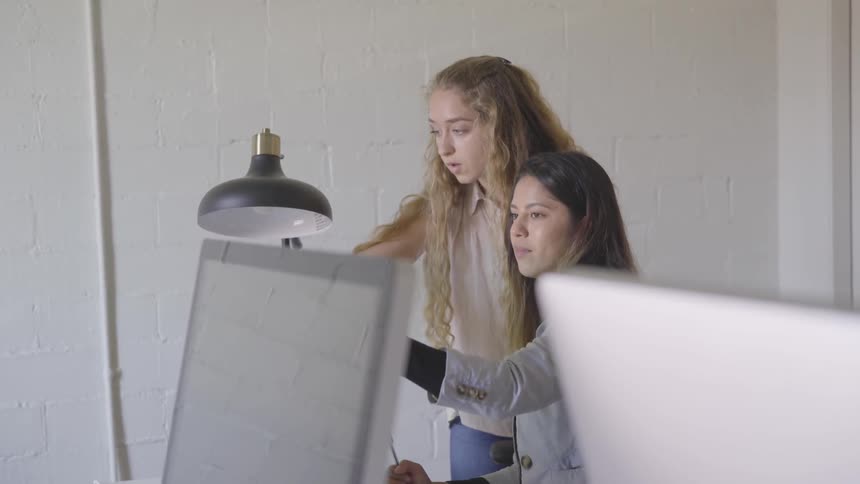 Two women working at a computer
