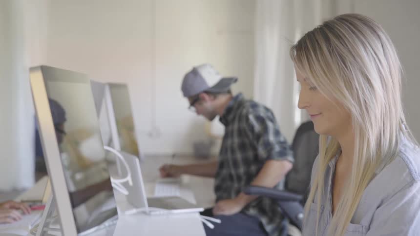 A man and a woman work on their computers