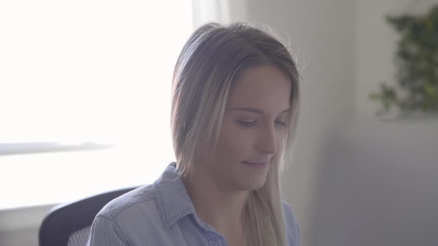 Woman sitting in front of a computer working in an office